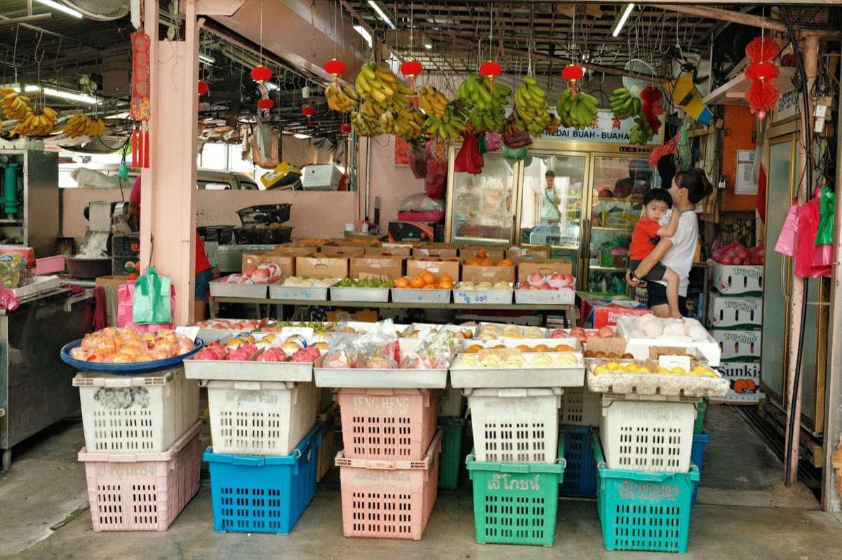 A traditional Penang shophouse grocery stacked with fruit and colourful crates