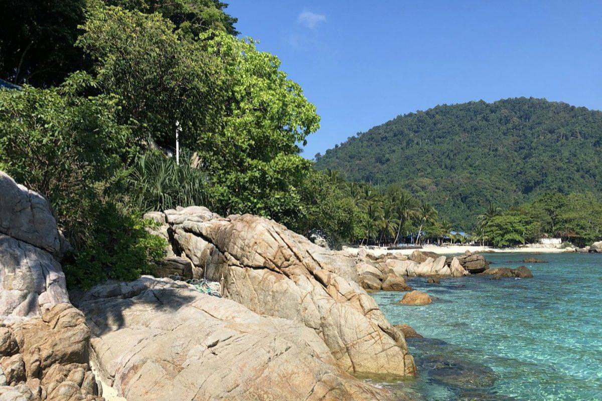 Clear turquoise water and granite boulders on a Perhentian island beach